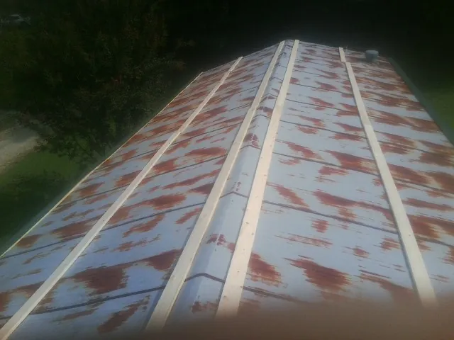 Rusted metal roof panels with new wood purlins before replacement — Storm Damage Roof Repair in Whitefield by Roofing Brothers