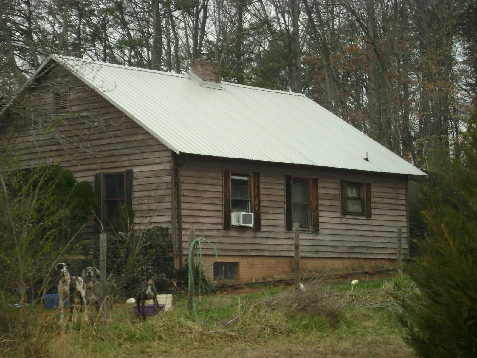 White metal roof on an old wood sided farmhouse, from a Metal Roof Installation job in Whitefield