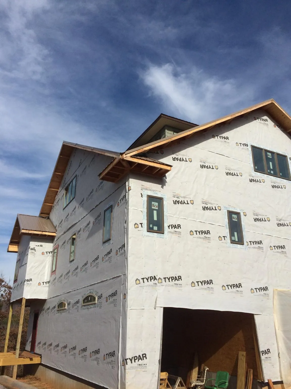 Stick built house wrapped in Typar with new roof framing and dormers in Whitefield